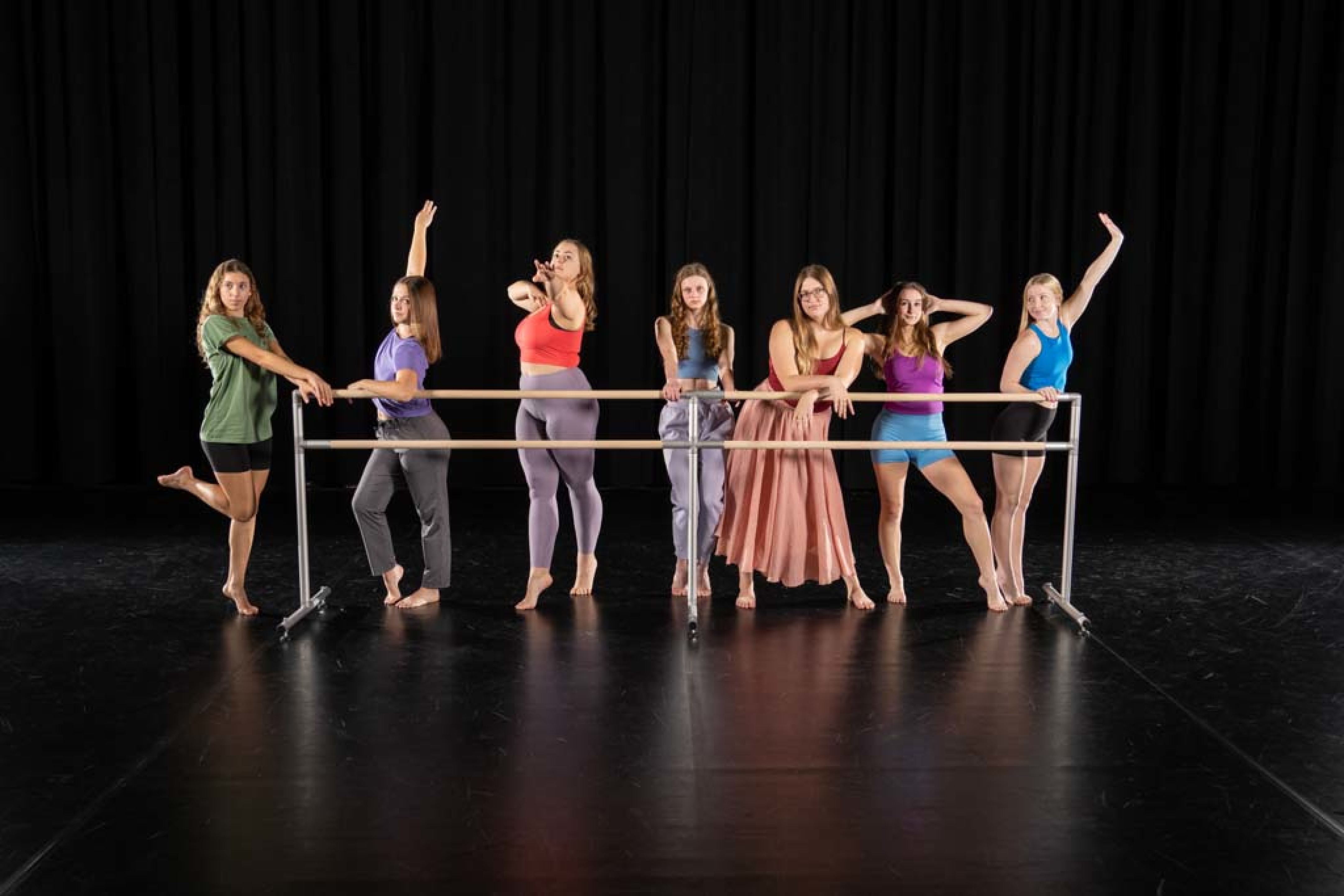 group of dancers on a stage, posing 