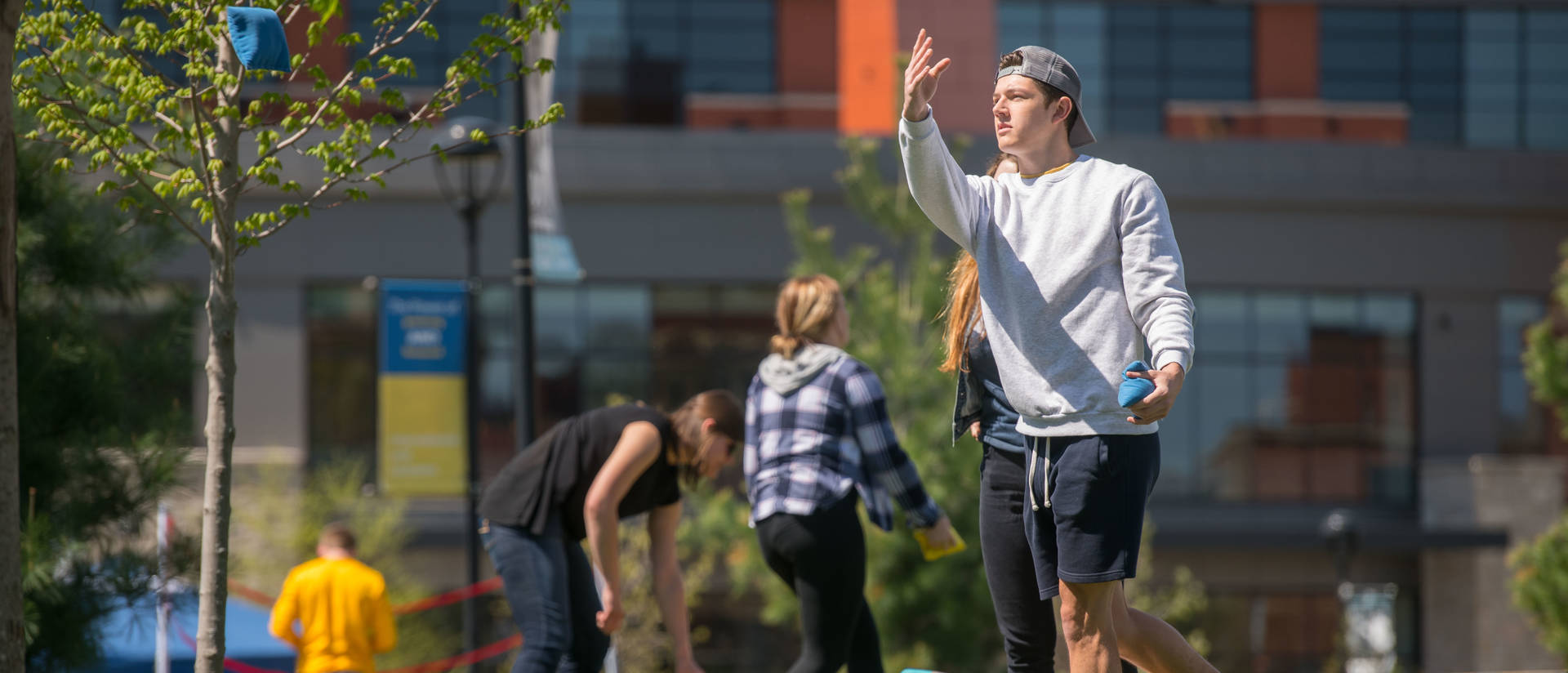 Student playing cornhole