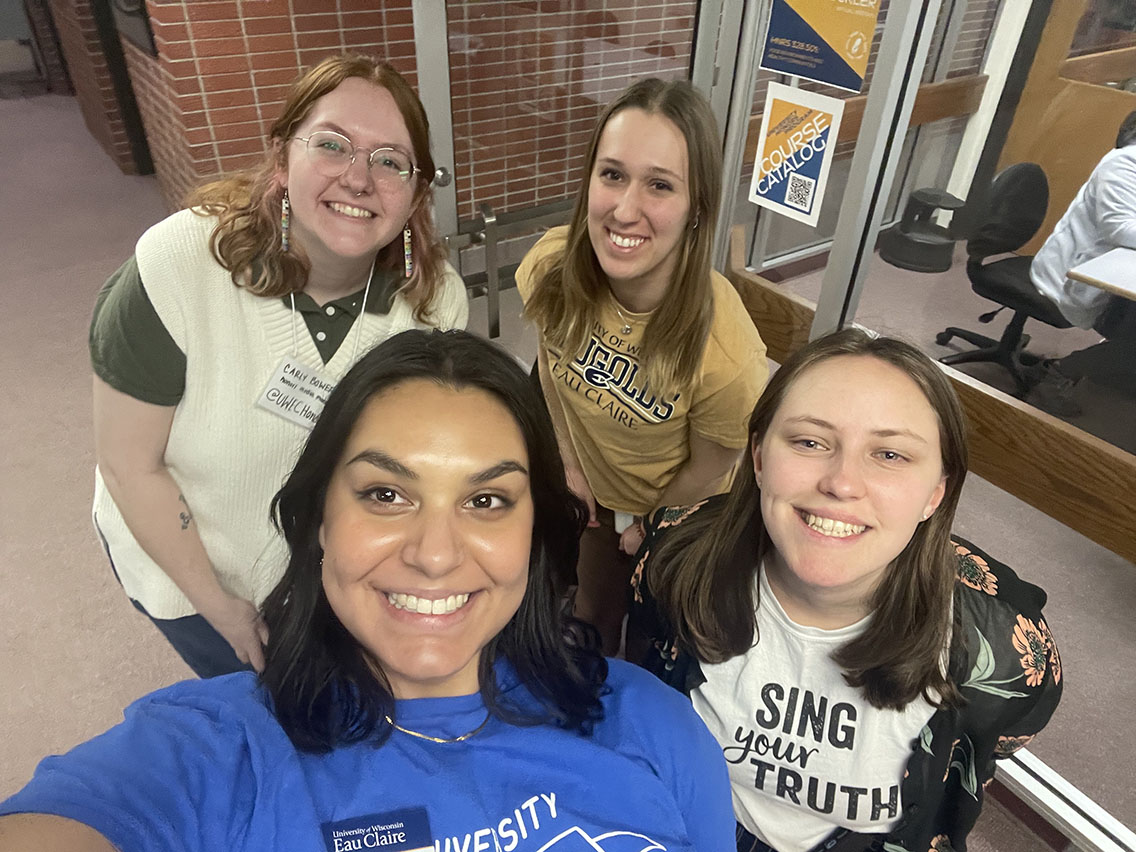 four smiling students take a selfie