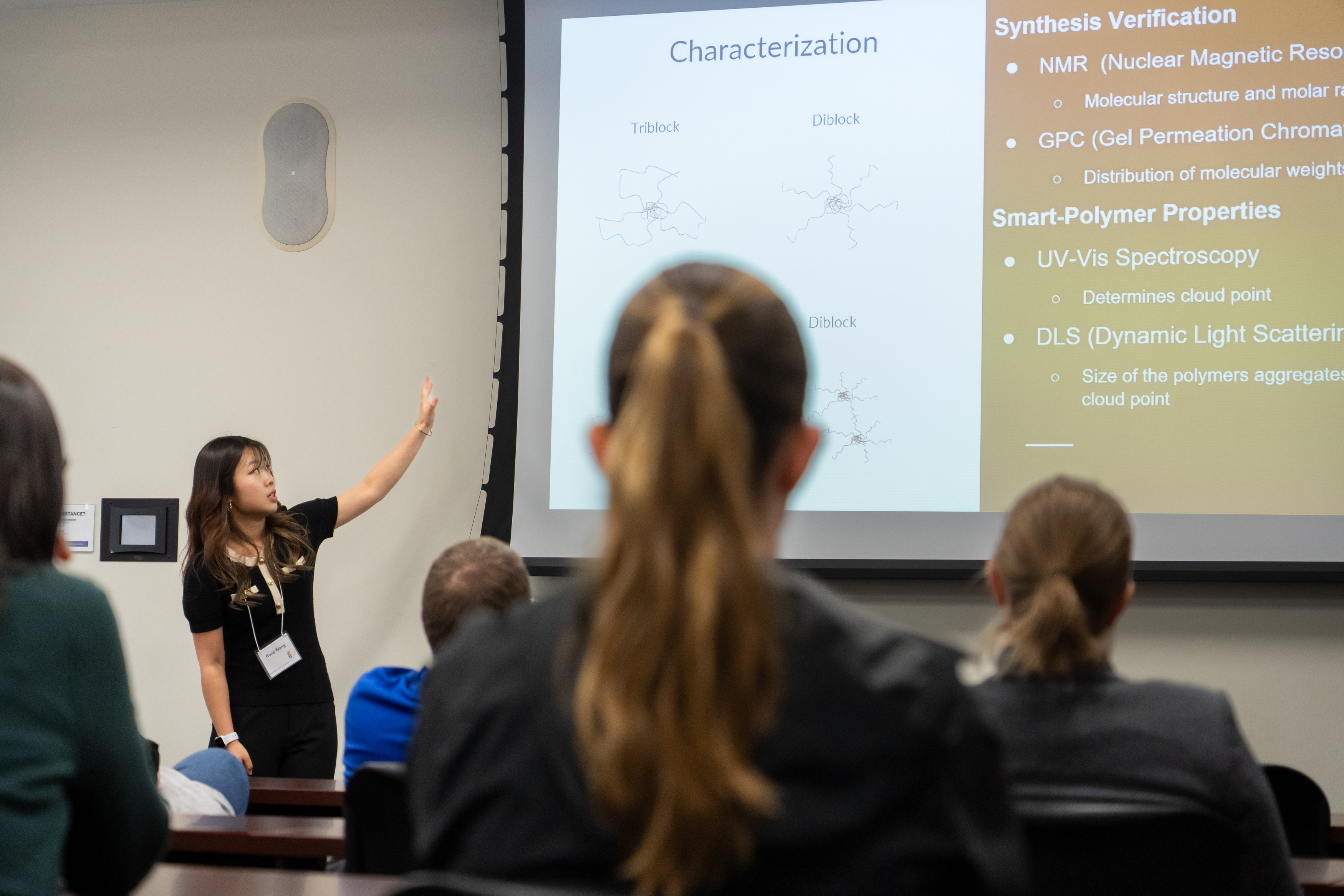 student presents research at the front of the room