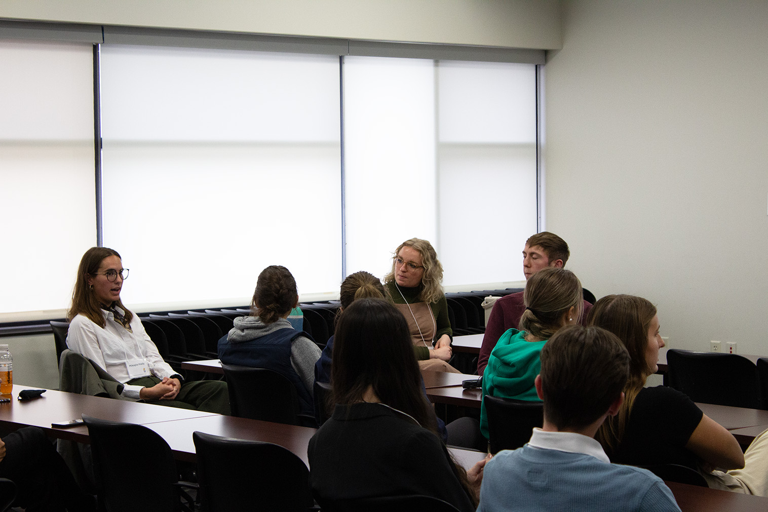 several students discuss sitting in a presentation room