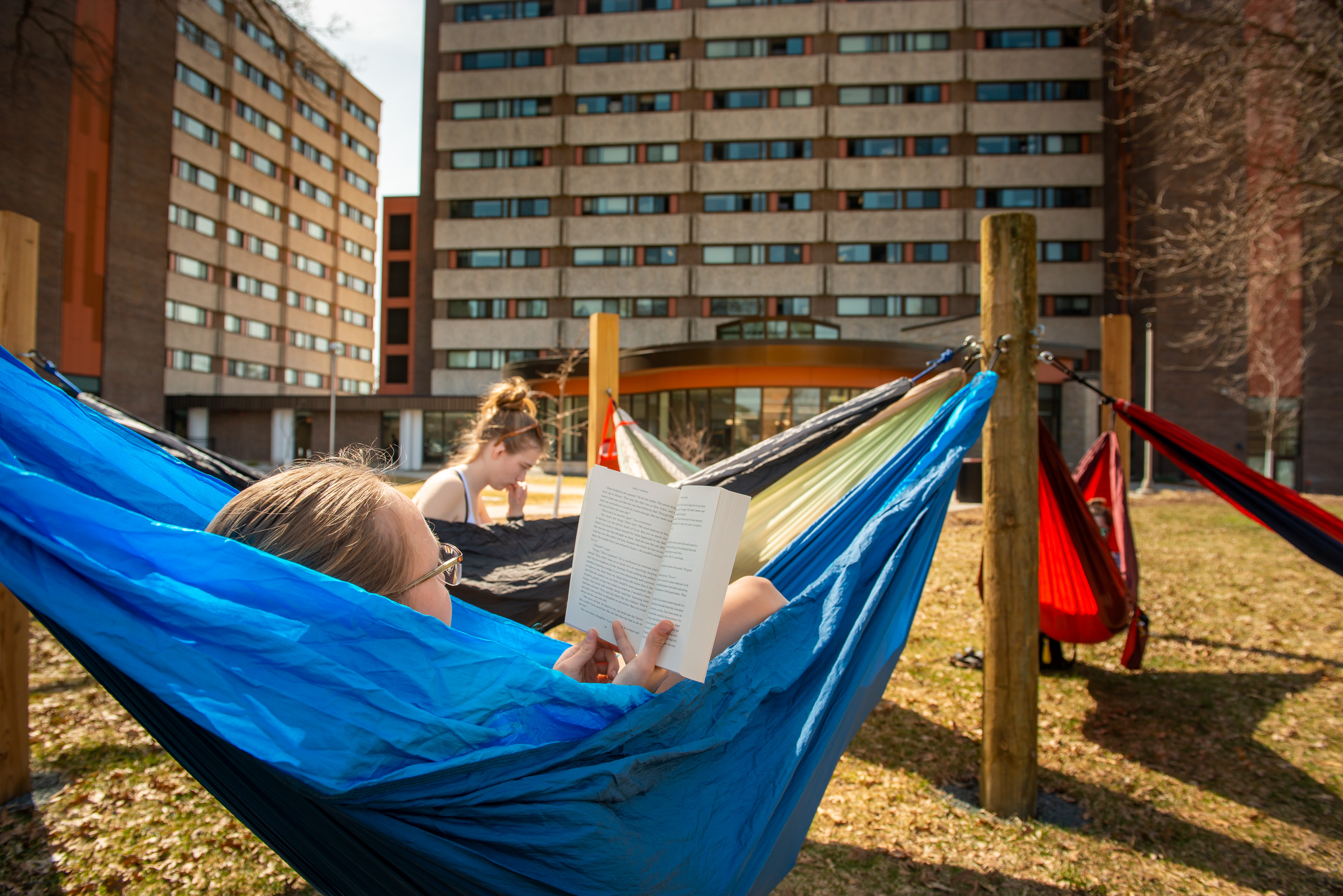 girls in hammocks on upper campus at UWEC, reading books