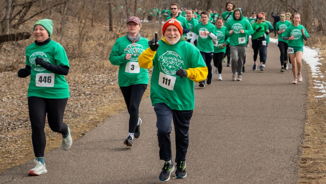 Man running on river path, with finger pointing up