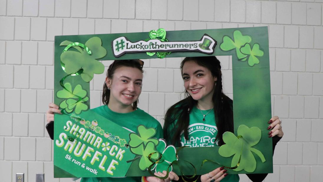 Two girls posing in a decorated frame