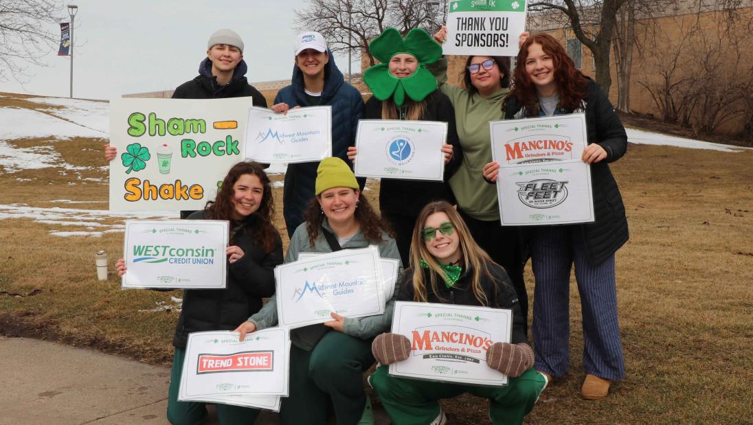 Group of supporters with signs of sponsors