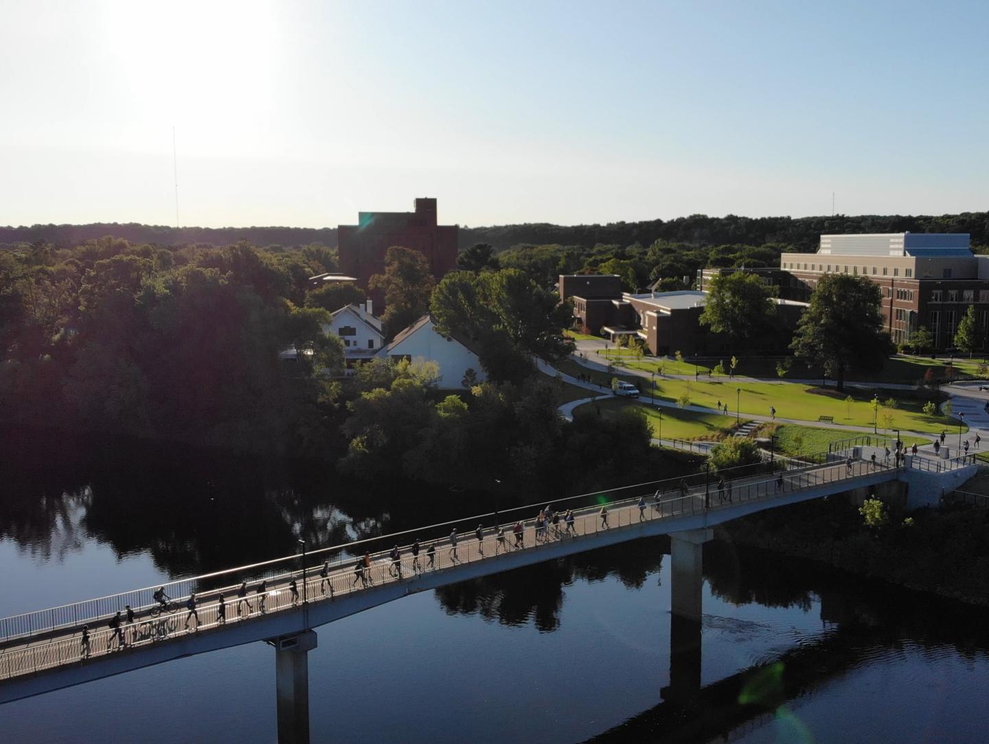 calm river aerial view of footbridge 