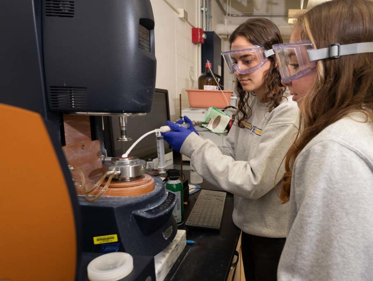 Foam lab research students using instrumentation