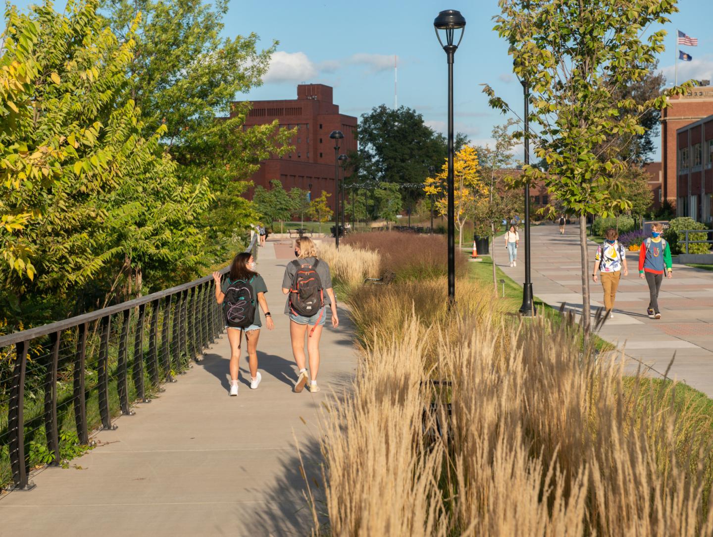 Students walking with masks on outside