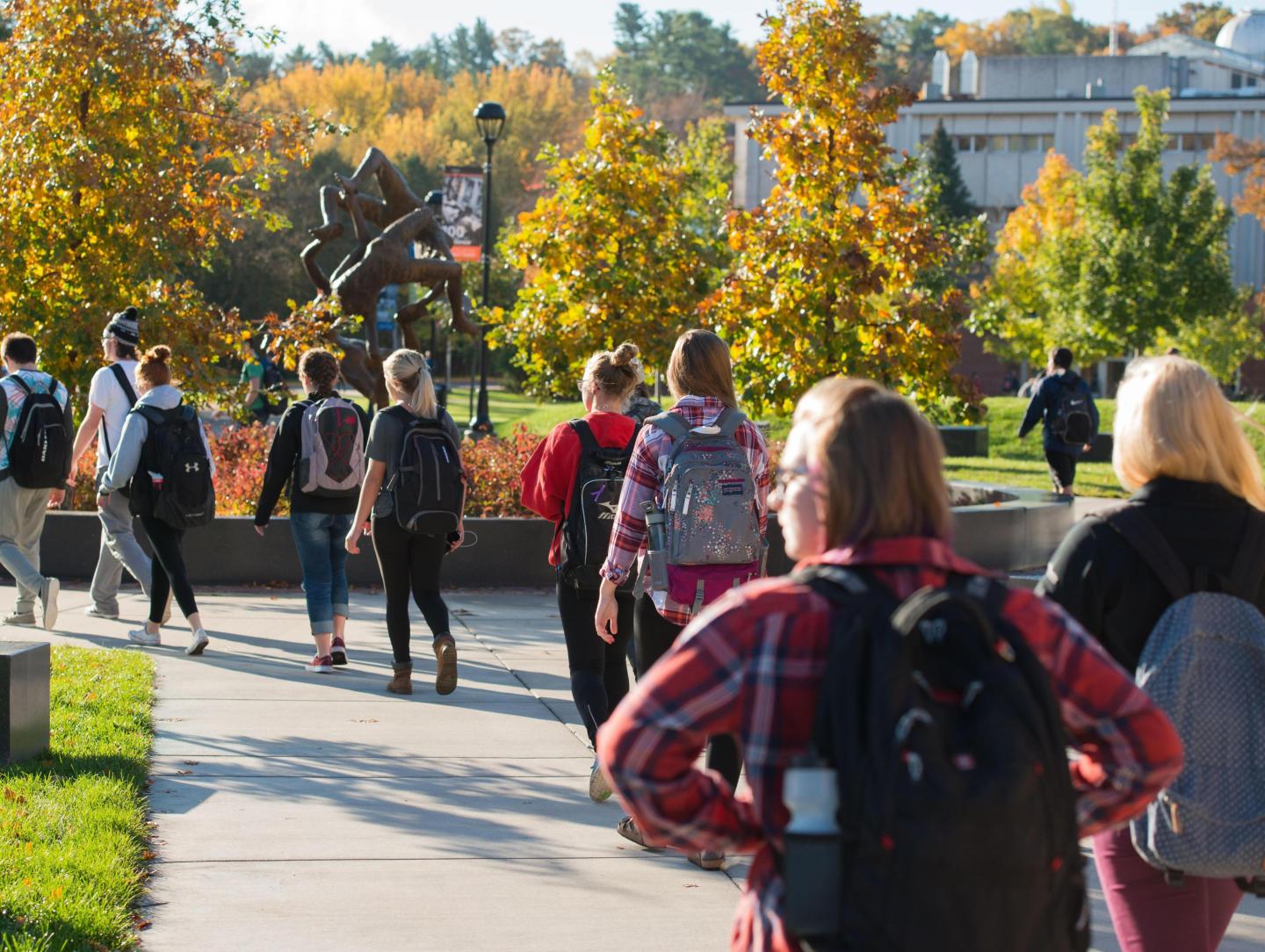 Students in the campus mall walk to class during the Fall.