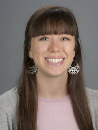 Headshot of a white woman with long brown hair.