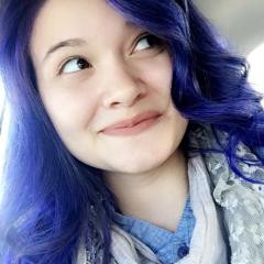 close-up of a female student, blue tinted hair, smiling