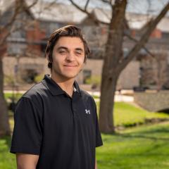 male student, dark hair, sunny day outside Phillips Science hall