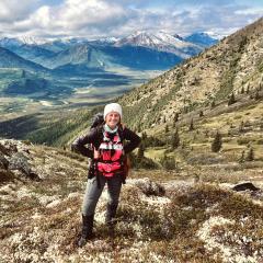 Bryanna poses on a mountainside in Alaska.