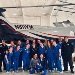 Deanna and classmates pose with a Flight-Med crew.