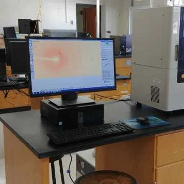 An X-ray diffractometer machine with a desktop computer screen