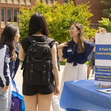 Students talking with an employer at the fall part-time job fair.