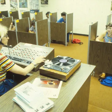 An instructor playing exam materials for students, 1979