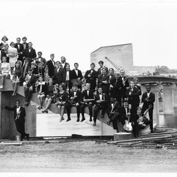 music group posing on unfinished footbridge UWEC 