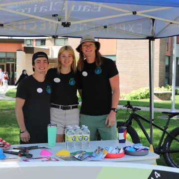 3 students pose at Recreation Tent at Tour de Rec