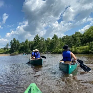 Students canoe trip in river