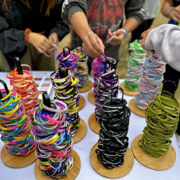 A bunch of colorful silicone bracelets representing a diverse array of queer identities.