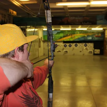 Archery range, man shooting bow at targets