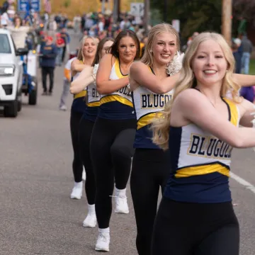 Dance team walking in UWEC homecoming parade 