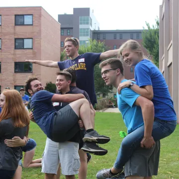 Students and staff in a piggy-back, teambuilding exercise