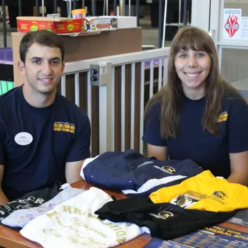 EAC staff at table dispersing tshirts