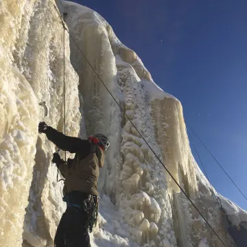 Student climbing frozen waterfall.