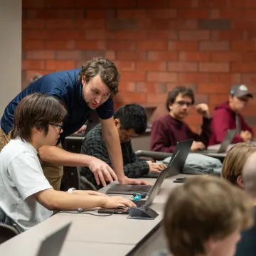 high powered computing classroom, instructor helping a student