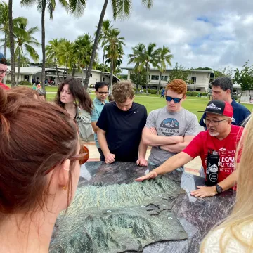 students listening to local history expert in Hawaii