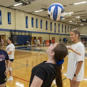 Blugold VB player Abigail Wherlund coaching youth at summer VB camp