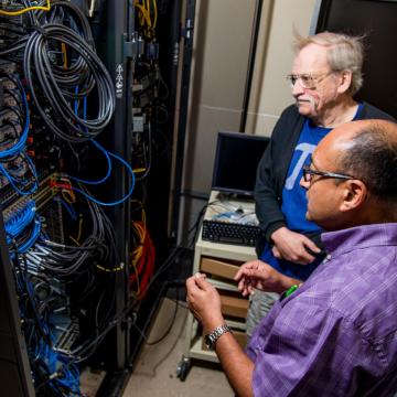 Faculty work closely with students on the supercomputer. Dr. Bhattacharyay and Dr. King working on the supercomputer.