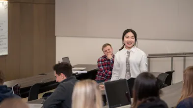 student standing and speaking in Finance class