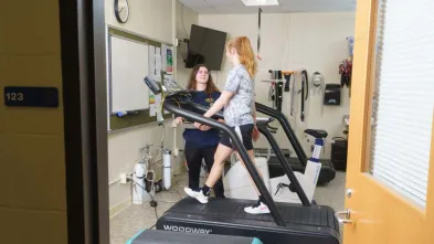 Exercise science lab, girl on treadmill with observer