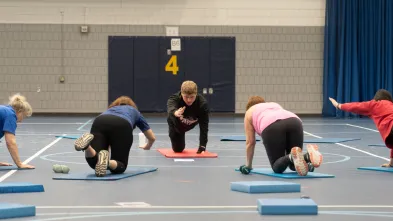 group class in community fitness with KINS teaching assistant