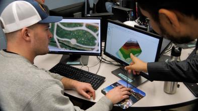 geospatial tech and analysis computers in use by two students