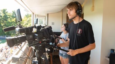 broadcast students shooting Blugold football in booth
