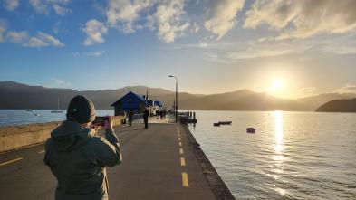 sunset on the water in Lithuania, student on a pier
