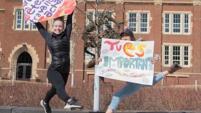 French students jumping by Sprites with signs in French