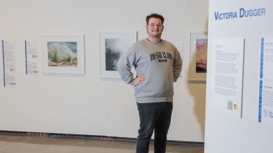 student posing for portrait in Foster Gallery