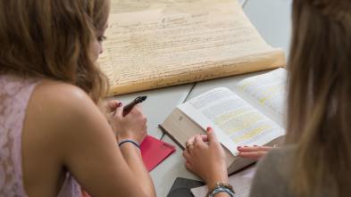 Two students discuss the Bill of Rights and U.S. Constitution in the Hibbard Hall Political Science study area
