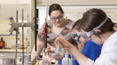 Students work on a chemistry experiment in a lab on campus.