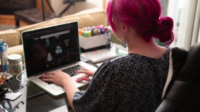 Student works at their computer in their dorm room.