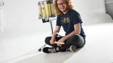 Andrew Smits in studio with drum drums and sticks stick