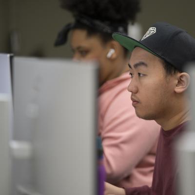 male student at a computer in CJ classroom 