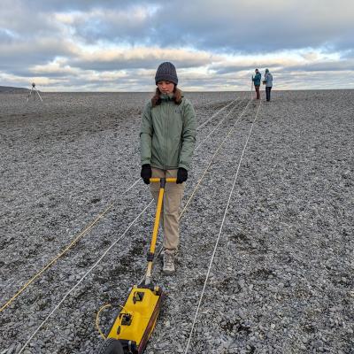 student operating ground radar on a beach 