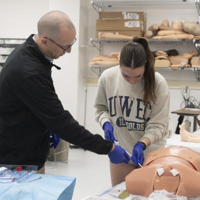 student in procedural skills lab learning chest tube 