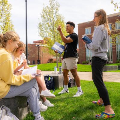 students outdoors for math class, laughing 